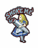 Close up view of Smokin' Buddies "Smoke Me" Alice Pin.