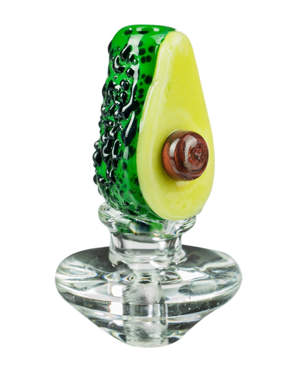 Image of the Avocadope Carb Cap for Puffco Peak, which is a glass avocado cut in half showing the avocado seed.