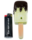 Front view of Empire Glassworks Choco Melon Popsicle Hand Pipe next to a lighter.