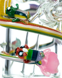 Close up view of Empire Glassworks Land of Ooo Mini Water Pipe showing characters from Adventure Time sliding down a rainbow.